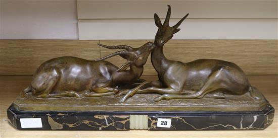 An art deco model of two seated gazelles on black marble base signed L. Carvin W.65cm